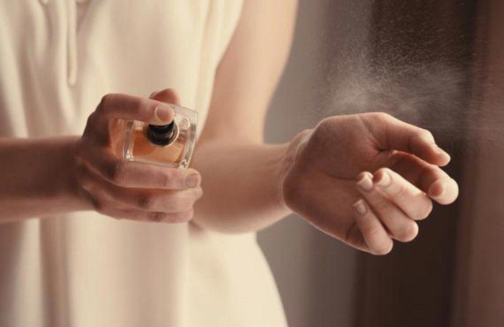 Retailer testing perfume sample longevity on skin